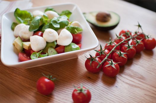 Prepared salad with vegetables: tomatoes, avocado