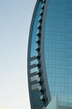 Modern building with many windows on sky background