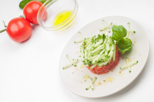 Tomatoes, olive oil and salad on the plate
