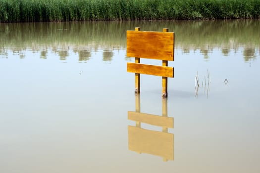 Wooden board standing in the middle of the lake