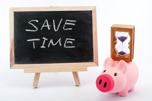 Save time concept image with piggy bank, hourglass and blackboard on white background