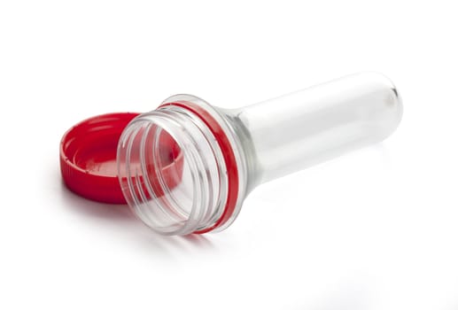 Plastic bottle preform with red cap on the white background