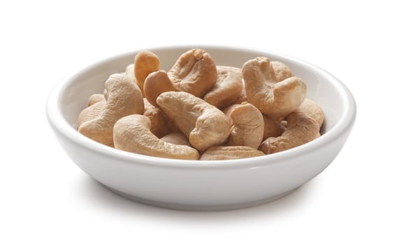 Handful of cashew nut on the white plate