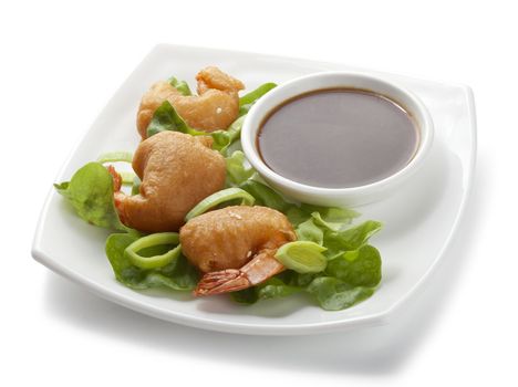 Shrimp tempura with lettuce, leek and soy sauce on the white palate