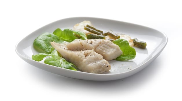 Two pieces of steamed fish with fried potato and kidney bean on lettuce