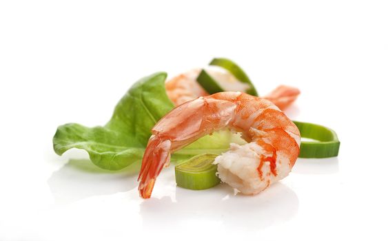 One boiled shrimp's tail with lettuce, leek and lemon on the white background
