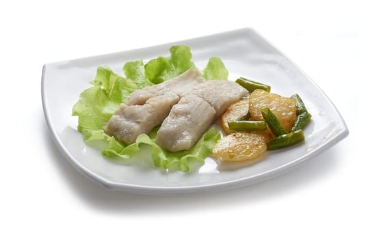 Two pieces of steamed fish with fried potato and kidney bean on lettuce