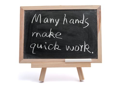 "Many hands make quick work" saying written on blackboard over white background