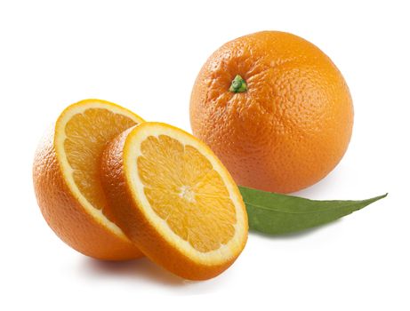 Whole and slices orange with leaf on the whit