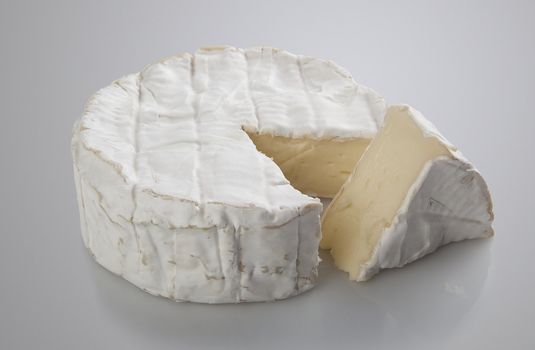 Isolated camembert cheese on the gray background