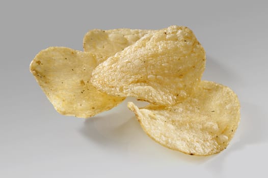 Some potato chips on the gray background