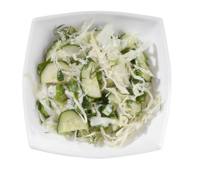 Salad with cabbage and cucumber in the white bowl