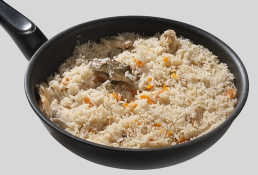 Pilau in the black pan on the gray