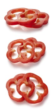 Slices of red paprika on the white background
