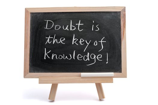 "Doubt is the key of knowledge" saying written on blackboard over white background