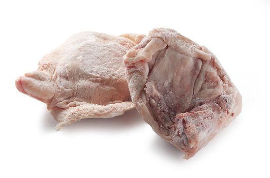 Two frozen piceses of chicken thigh on the white