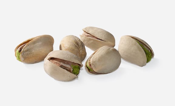 Some isolated pistachios on the gray background