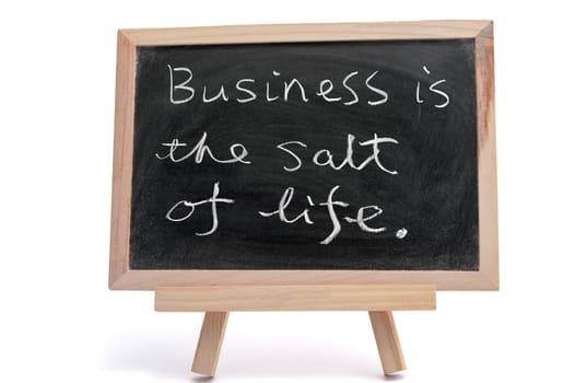 "Business is the salt of life" saying written on blackboard