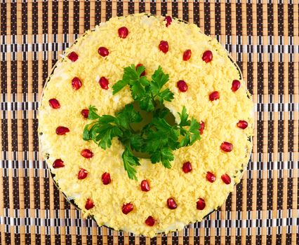 Salad with boiled egg, cream sauce and pomegranate seeds on a plate