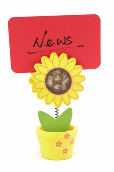 News word written on red paper of sun flower pot clip