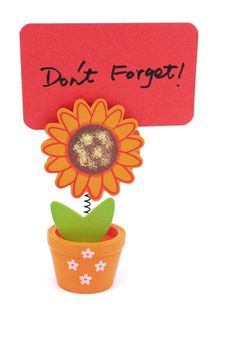 Don't forget words written on red paper of sun flower pot clip