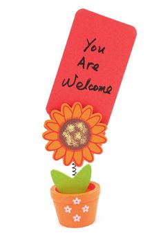 You are welcome words written on red paper of sun flower pot clip