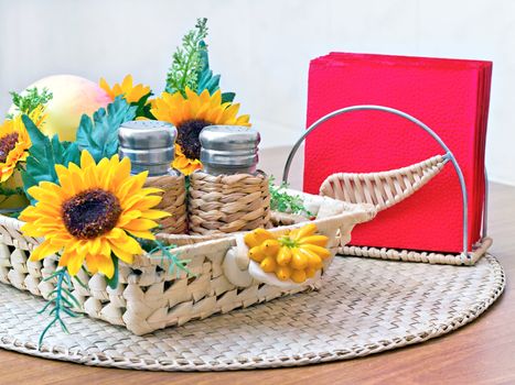 salt pepper and napkins on the table decorated with flowers