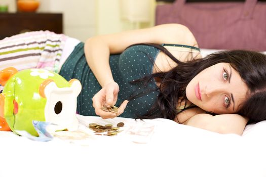 Woman at home laying in bed desperate not having a job left with few money