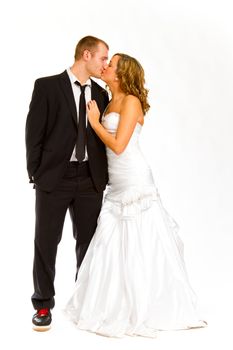 A beautiful bride and a handsome groom are isolated against a white background in the studio to create this bridal wedding portrait.