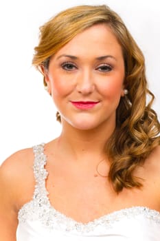 An isolated portrait of a beautiful brunette bride in the studio against a white background with her in her wedding dress.