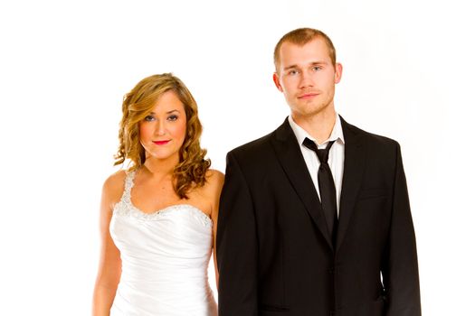 A beautiful bride and a handsome groom are isolated against a white background in the studio to create this bridal wedding portrait.