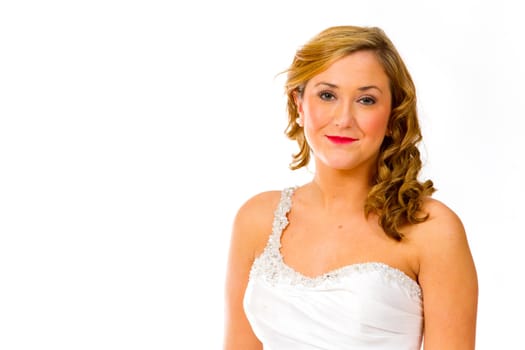 An isolated portrait of a beautiful brunette bride in the studio against a white background with her in her wedding dress.