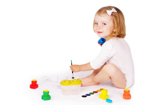 Pretty girl painting on floor isolated on white