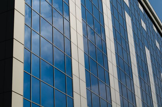 Blue sky reflected in the windows of office building