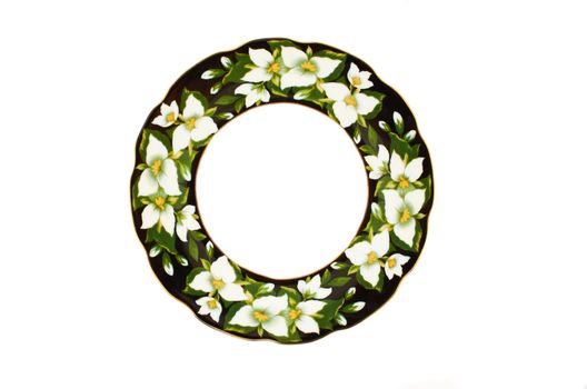 Round ceramic plate with wavy edges and a floral pattern on a white background
