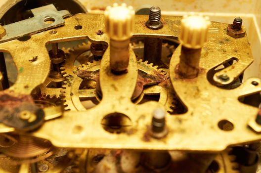 Old rusty gears of hours close up