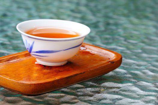 A cup of tea on a wooden coaster
