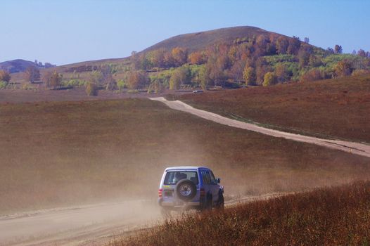 Off-road vehicle running in Bashang grassland, Hebei province, China.