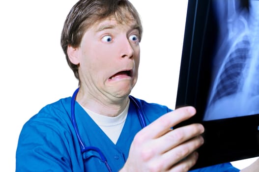 Male doctor looking with humorous shock at x ray