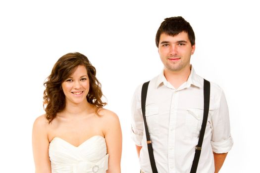 An attractive woman and her handsome husband wear their wedding attire in the studio agains an isolated white background.