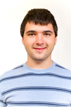 A portrait of a man in a striped sweater in the studio against an isolated white background.