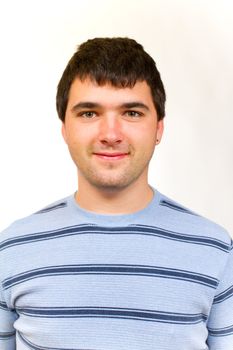 A portrait of a man in a striped sweater in the studio against an isolated white background.