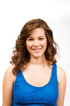 An attractive girl in a blue shirt against an isolated white backgtround in the studio.