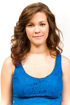 An attractive girl in a blue shirt against an isolated white backgtround in the studio.