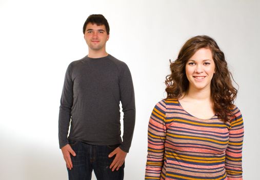 A man and a woman in a studio against an isolated white background for this simple portrait.