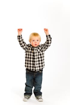 A young boy in a plaid shirt poses for this portrait in the studio against an isolated white background.