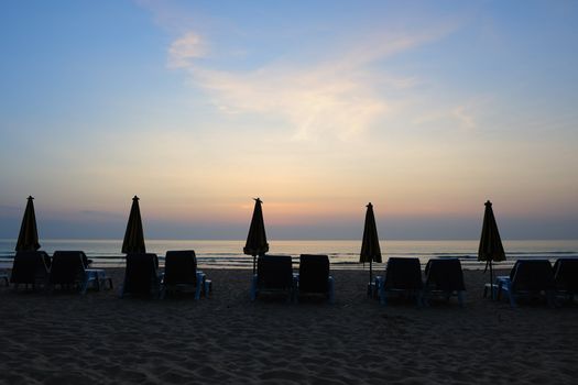 Beach landscape with a row of folded umbrella in Phuket Island, Thailand