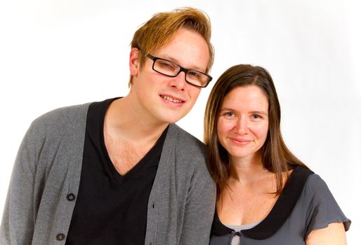 A man and woman pose for this family portrait in the studio against an isolated white background.