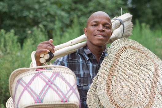 Stock photograph of a black South African entrepreneur small .business broom salesman in Hilton, Pietermaritzburg, Kwazulu-Natal