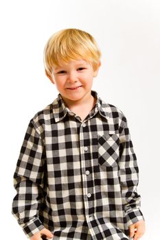 A young boy in a plaid shirt poses for this portrait in the studio against an isolated white background.